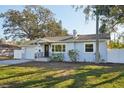 Charming single-story home with blue and white exterior, landscaped lawn, and welcoming front entrance at 2320 E Harbor S Dr, St Petersburg, FL 33705