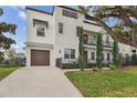 Charming two-story home features a private garage, front yard, and balcony at 401 S Melville Ave, Tampa, FL 33606