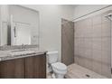 Modern bathroom featuring a tiled shower, granite countertop, and wood vanity at 4170 Polynesia Rd, North Port, FL 34288