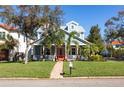 Charming two-story home featuring a welcoming front porch and a beautifully landscaped front yard at 4301 W San Luis St, Tampa, FL 33629