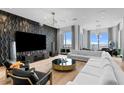 Elegant living room featuring modern design, textured wall, and floor-to-ceiling windows at 449 S 12Th St # 2702, Tampa, FL 33602