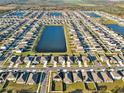 Expansive aerial view of the neighborhood, showcasing the community's layout and nearby lakes at 5456 Logan Cave Ave, Wimauma, FL 33598