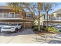 Inviting two-story townhome featuring a one-car garage and a beautifully landscaped front yard at 7001 Interbay Blvd # 181, Tampa, FL 33616