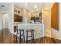 Kitchen bar with decorative tile, stools and lighting, perfect for casual dining at 7001 Interbay Blvd # 181, Tampa, FL 33616