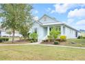 A beautiful home with a well-kept lawn and mature trees in a sunny neighborhood at 704 Winterside Dr, Apollo Beach, FL 33572