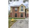 Two story brick apartment with a yellow accent wall and window at 8728 Mallard Reserve Dr # 102, Tampa, FL 33614