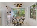 Inviting breakfast nook with table, chairs, ceiling fan and a view of lush greenery at 1012 Pearce Dr # 101, Clearwater, FL 33764