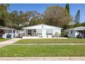 Charming single-story home with a well-manicured lawn, clean lines, and inviting curb appeal at 1044 Charles St, Clearwater, FL 33755