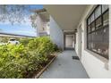 Exterior view of condo showing walkway, bushes and designated parking at 11800 Park Blvd # 505, Seminole, FL 33772
