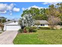 Charming single-story home with a well-maintained lawn, brick driveway, and attached two-car garage at 1389 47Th Ne Ave, St Petersburg, FL 33703