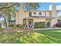 Inviting home exterior featuring a well-kept lawn and a partially screened porch entry at 15 Emerald Bay Dr, Oldsmar, FL 34677