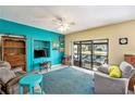 Cozy living room with vibrant walls and a sliding glass door leading to the outdoors at 15 Emerald Bay Dr, Oldsmar, FL 34677