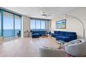 Spacious living room features ocean views, with a plush sofa and stylish decor for relaxation at 1560 Gulf Blvd # 1202, Clearwater Beach, FL 33767
