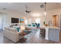Open-concept living room with tile floors, comfortable seating, and a dining area at 16388 Cape Horn Blvd, Punta Gorda, FL 33955