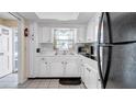 Functional kitchen featuring white cabinets and appliances at 1662 S Lake Ave # 2, Clearwater, FL 33756
