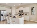Beautiful kitchen with stainless steel appliances, granite countertops and an island with chairs at 17061 James Trl, Parrish, FL 34219