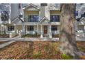 A closer view of a townhome exterior showing well-kept landscaping, individual entrances, and architectural details at 1801 N Morgan St # 6, Tampa, FL 33602
