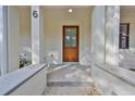 Inviting front entrance featuring a wood door, covered porch, and modern design elements at 1801 N Morgan St # 6, Tampa, FL 33602