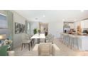 Open concept living and dining area with a large marble table and modern decor at 1808 Cobb Trl, Parrish, FL 34219