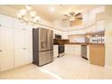Well-lit kitchen with stainless steel appliances, white cabinets, and a breakfast bar overlooking the dining area at 2166 Andrews Ct, Dunedin, FL 34698