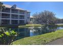 Condo complex with screened balconies overlooking a beautiful pond with fountains and well-maintained landscaping at 2210 Vista Del Sol Cir # 519, Lutz, FL 33558