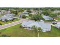 Aerial view of a well-maintained community with mature trees, manicured lawns, and varied home styles at 2301 Grenoble Pl # 1, Sun City Center, FL 33573