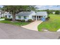 Well-maintained single-story home with mature landscaping and a long private driveway at 2301 Grenoble Pl # 1, Sun City Center, FL 33573
