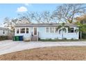 Charming one-story home with blue siding, a paved driveway, and mature trees, perfect for peaceful living at 3307 S Manhattan Ave, Tampa, FL 33629