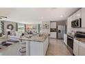 Open concept kitchen with stainless steel appliances and views into the living room at 35695 Durand Ct, Zephyrhills, FL 33541