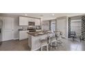 White kitchen with granite countertops, stainless steel appliances and cozy bar seating at 35695 Durand Ct, Zephyrhills, FL 33541