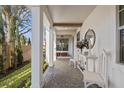 Welcoming front porch with white columns, brick flooring, and stylish decor at 3721 Iris N St, St Petersburg, FL 33704