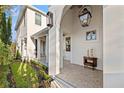 Charming front porch featuring brick flooring, decorative lighting, and refined decor at 3721 Iris N St, St Petersburg, FL 33704