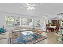 Bright living room featuring a large window, patterned rug, and an open floor plan at 410 Berwick Ave, Temple Terrace, FL 33617