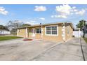 A lovely view of a quaint house with a long driveway leading up to the front entrance of the home at 4931 Murray Hill Dr, Tampa, FL 33615