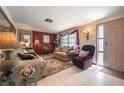 Comfortable living room featuring neutral-toned sofas, an area rug, and natural light at 1133 Powersong St, Holiday, FL 34690