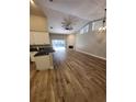 Open-concept living area with fireplace, hardwood floors, and sliding glass doors at 11638 Hidden Hollow Cir, Tampa, FL 33635