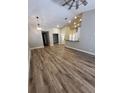 Spacious living area showcasing hardwood floors, modern lighting and neutral color scheme at 11638 Hidden Hollow Cir, Tampa, FL 33635