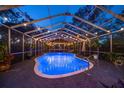 Relaxing pool area featuring a covered, screened-in pool with patio area and string lights at 13225 108Th Ave, Largo, FL 33774