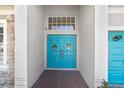 Inviting double doors, a stylish entrance to the home, decorated with wreaths at 13235 Graham Yarden Dr, Riverview, FL 33579