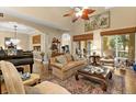 Open living room with a high ceiling, hardwood floors, elegant furniture, and access to the patio at 15 Jefferson S Ct, St Petersburg, FL 33711