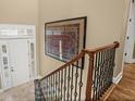 A view of the staircase with decorative railing and art, leading to the upper level at 15 Jefferson S Ct, St Petersburg, FL 33711
