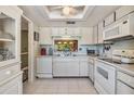 Bright kitchen with white cabinetry, modern appliances, and a window offering natural light and a view to the outside at 2549 Royal Pines Cir # 16H, Clearwater, FL 33763