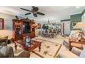 Spacious living and dining area with stylish furnishings, a ceiling fan, and a large rug with palm tree designs at 2549 Royal Pines Cir # 16H, Clearwater, FL 33763