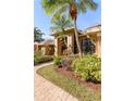 Stunning entrance featuring an arched entryway, lush landscaping and a brick walkway at 2966 Eagle Estates W Cir, Clearwater, FL 33761