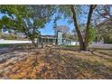Quaint single-story home with blue siding, front ramp, chimney, and trees at 3127 W Lambright St # A, Tampa, FL 33614