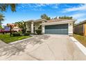 Charming home boasting a well-manicured lawn, mature landscaping and two-car garage at 3616 Cypress Meadows Rd, Tampa, FL 33624