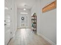 Inviting entryway featuring light tile floors and a decorative welcome sign at 6127 164Th E Ave, Parrish, FL 34219