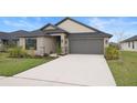 Lovely single-story home with a two-car garage and meticulously landscaped front yard at 6127 164Th E Ave, Parrish, FL 34219