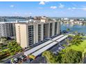 Aerial view showcasing the condo building, covered parking, and well-maintained landscaping at 690 Island Way # 1003, Clearwater Beach, FL 33767