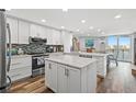 Bright, updated kitchen features white cabinets, stainless appliances, and a large center island at 690 Island Way # 1003, Clearwater Beach, FL 33767